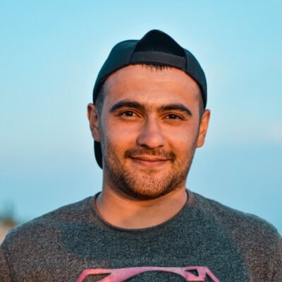 A man wearing a Superman shirt and hat.