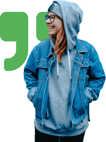 A woman in a hoodie and jeans with the quote icon in the background.